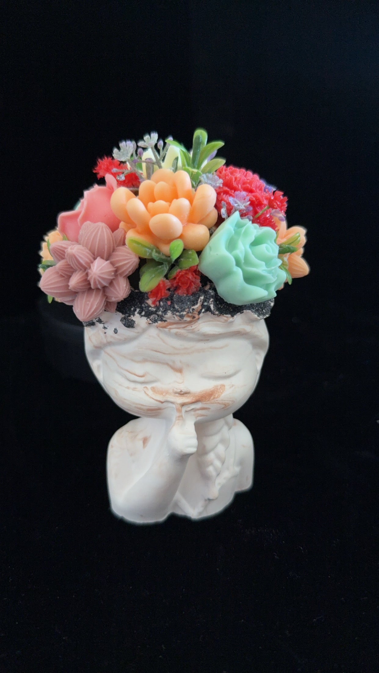 Small facial statute with flower